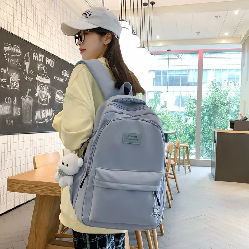 Large capacity nylon backpack for women, waterproof and wear-resistant, in solid colour with zips and straps