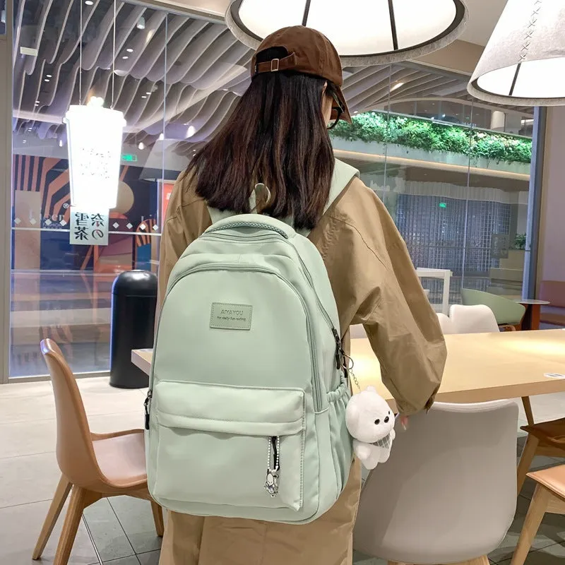 Large capacity nylon backpack for women, waterproof and wear-resistant, in solid colour with zips and straps