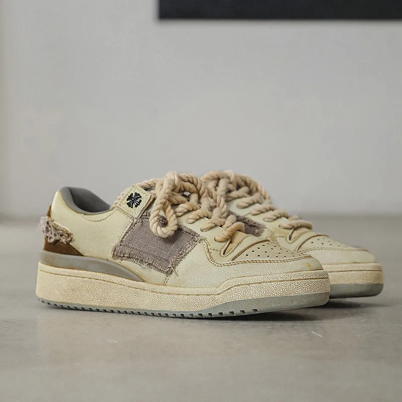 Beige low-top skateboard shoes with vintage patch design and rubber sole