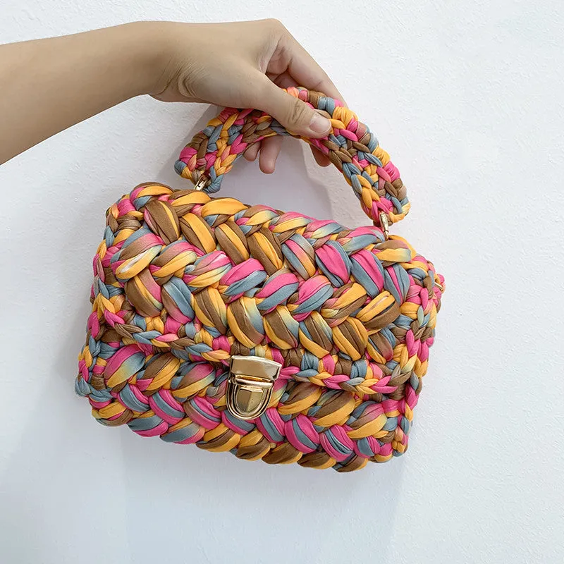 Hand knitted crochet tote crossbody bag in cotton with lock closure, yellow colour, on a plain background