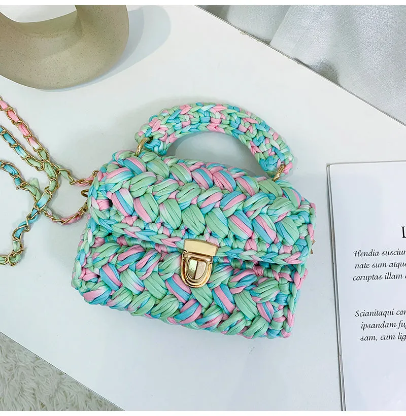 Hand knitted crochet tote crossbody bag in cotton with lock closure, yellow colour, on a plain background