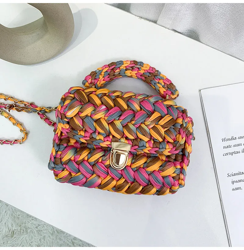 Hand knitted crochet tote crossbody bag in cotton with lock closure, yellow colour, on a plain background