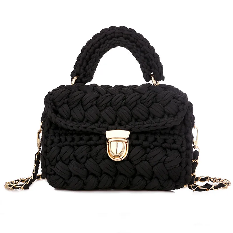 Hand knitted crochet tote crossbody bag in cotton with lock closure, yellow colour, on a plain background