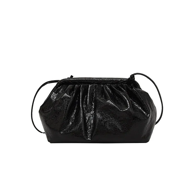 Shell-shaped crossbody bag with hair clip attachment in multiple colour options showing organised internal compartments