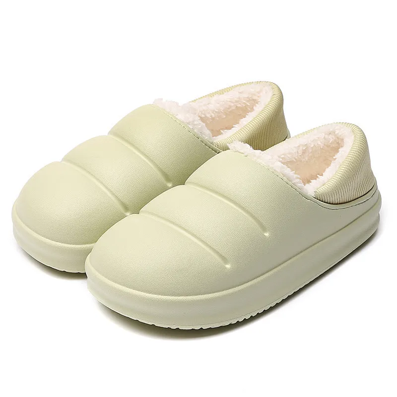 Yellow women's EVA overshoe slippers with plush lining and a textured non-slip sole on a wooden deck.