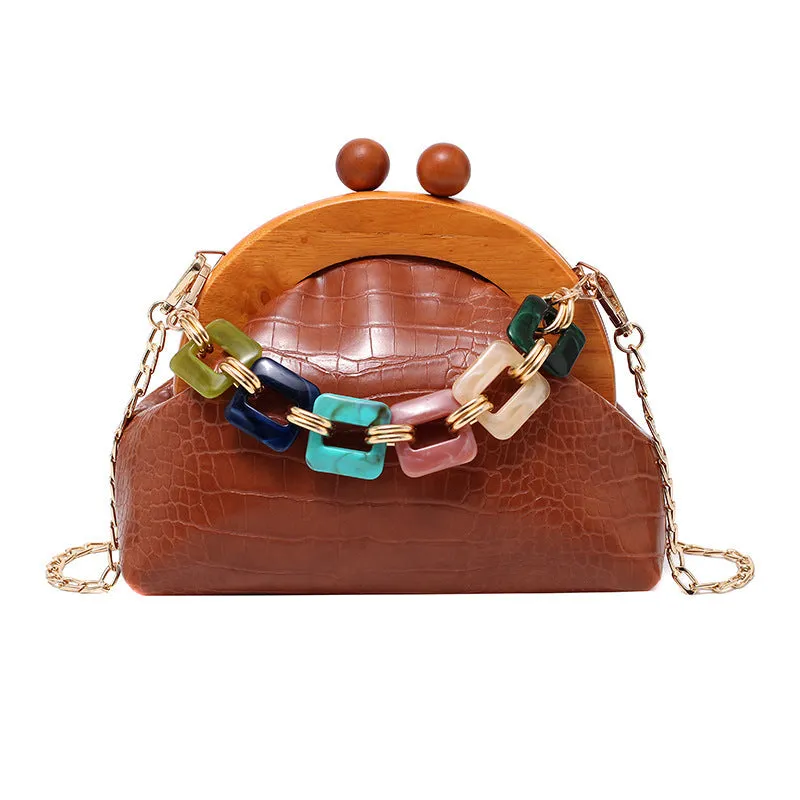 Women's shell-shaped PU clutch bag with diamond element and chain strap in black