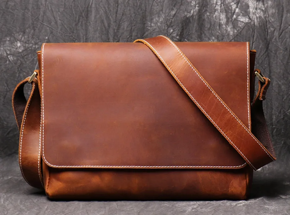 Vintage brown cowhide men's messenger bag showing front flap and adjustable shoulder strap