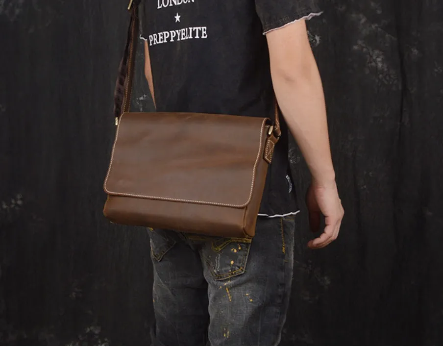 Vintage brown cowhide men's messenger bag showing front flap and adjustable shoulder strap