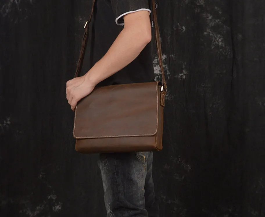 Vintage brown cowhide men's messenger bag showing front flap and adjustable shoulder strap