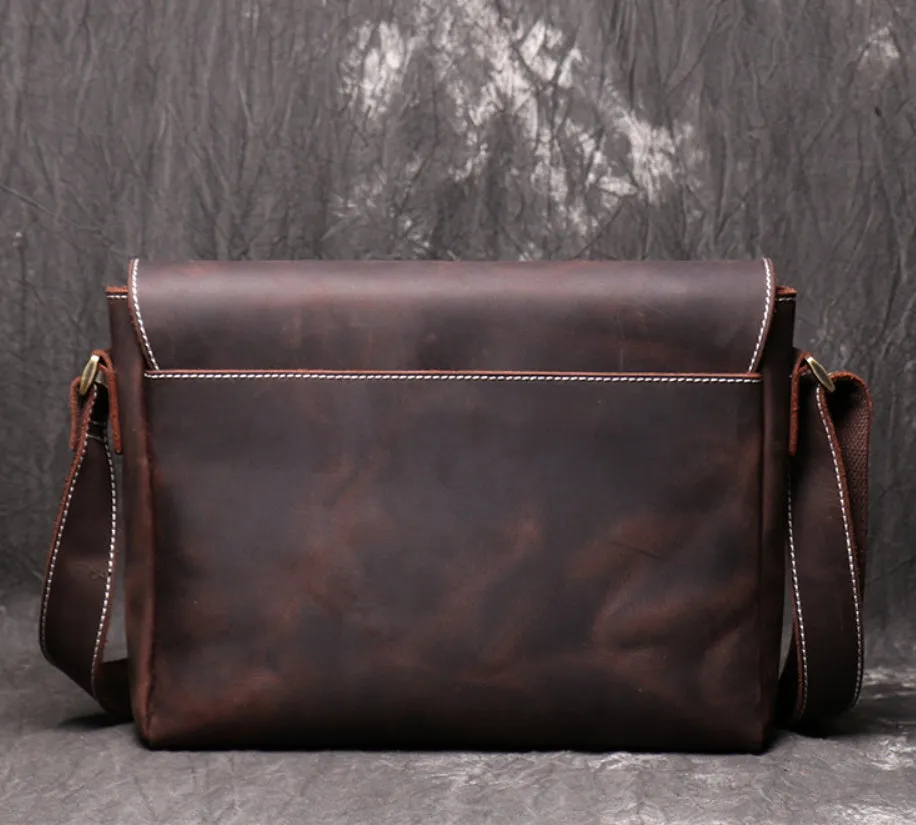 Vintage brown cowhide men's messenger bag showing front flap and adjustable shoulder strap