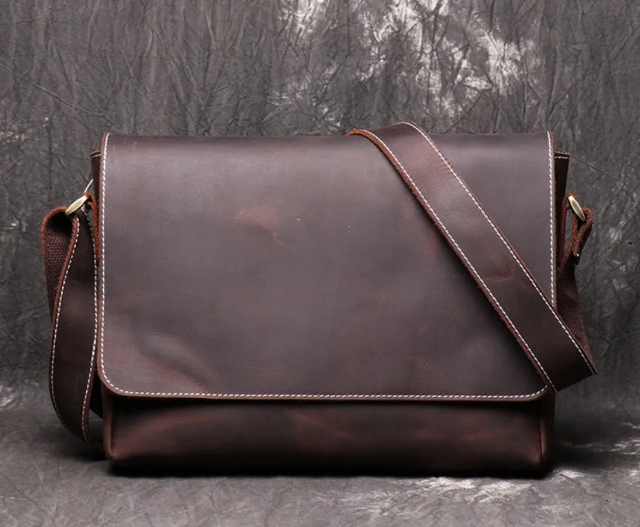 Vintage brown cowhide men's messenger bag showing front flap and adjustable shoulder strap