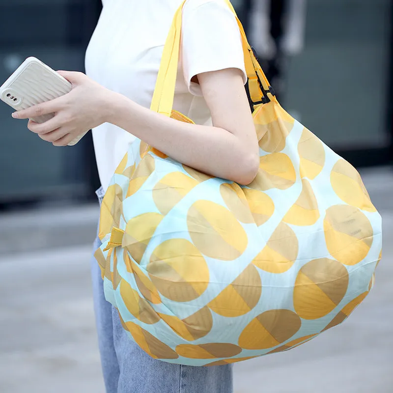 Large capacity foldable nylon shopping bag in beige yellow, open and full with groceries