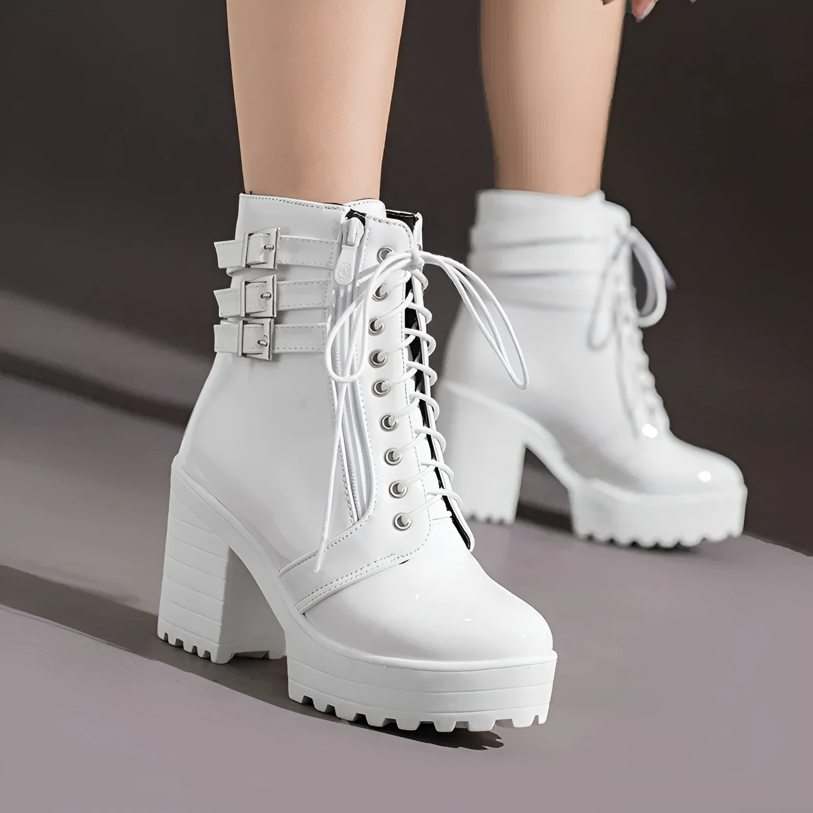 Women's black thick-heeled short boots with lace-up front and round toe on a rubber sole.