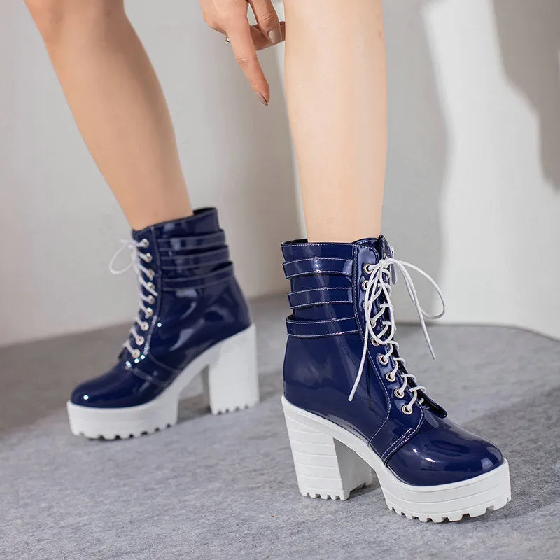 Women's black thick-heeled short boots with lace-up front and round toe on a rubber sole.