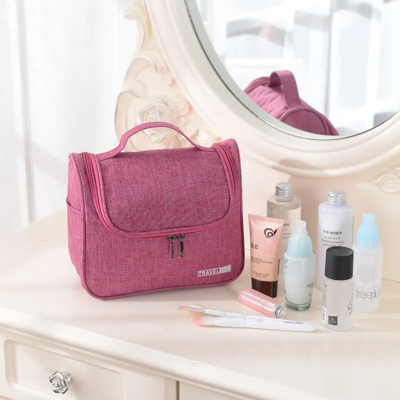Cube-shaped cationic toiletry bag in black, folded open to show interior storage space