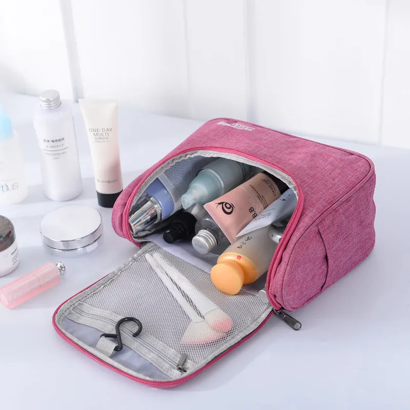 Cube-shaped cationic toiletry bag in black, folded open to show interior storage space