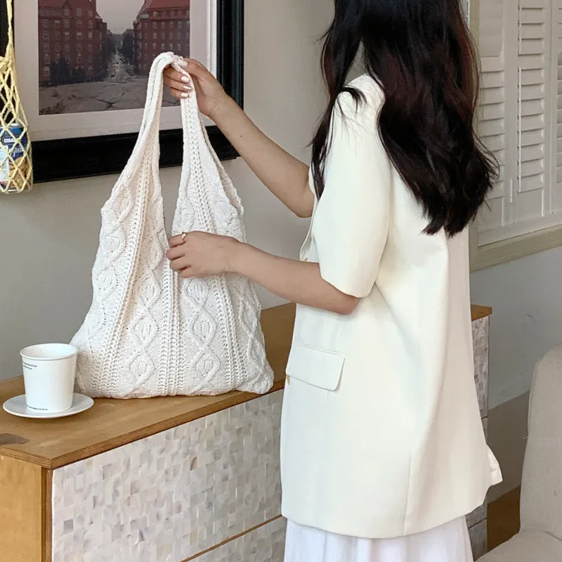 Retro hollow knitted wool yarn women's shoulder tote bag in a solid colour with double straps.