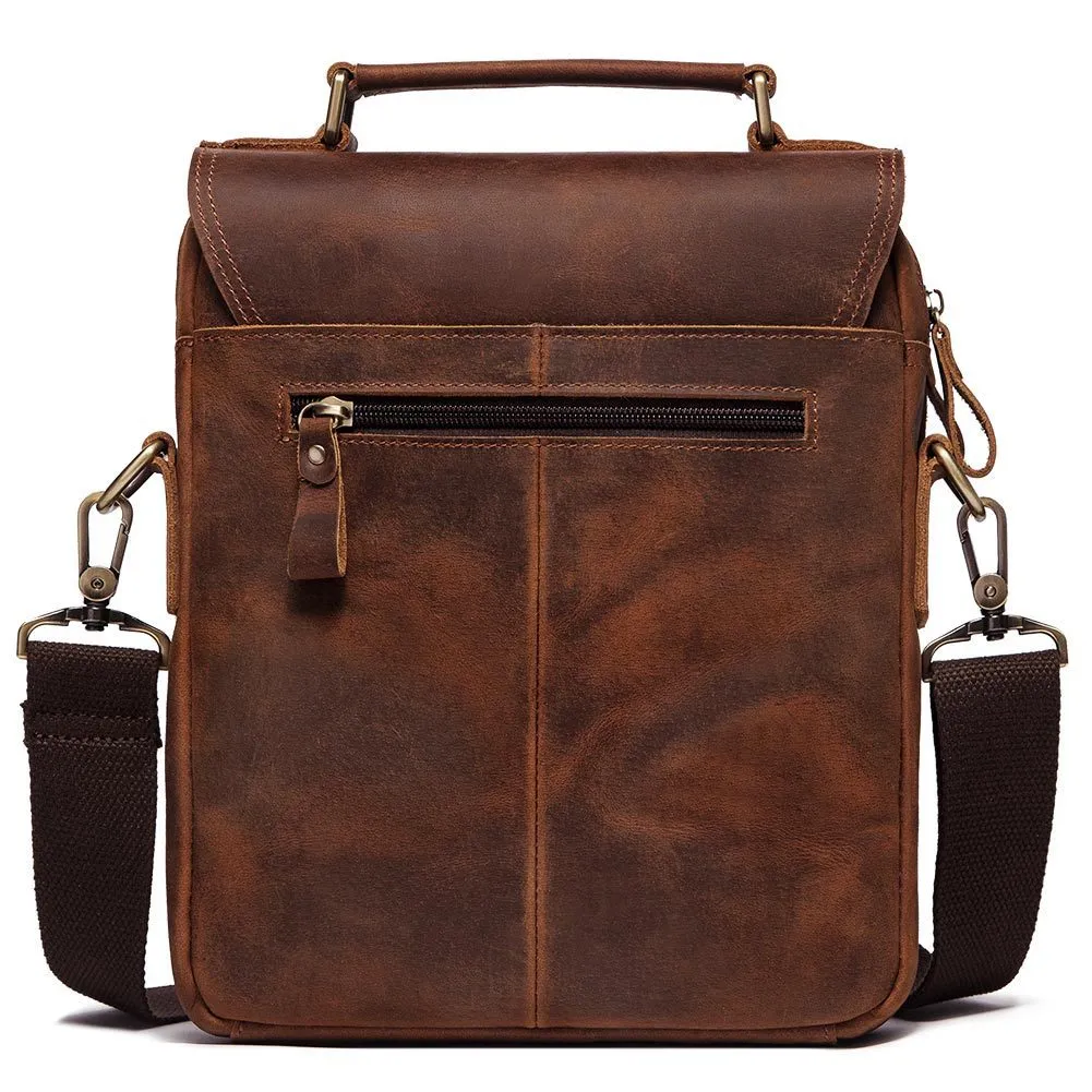 Men's brown leather shoulder bag with zipper buckle closure on soft surface