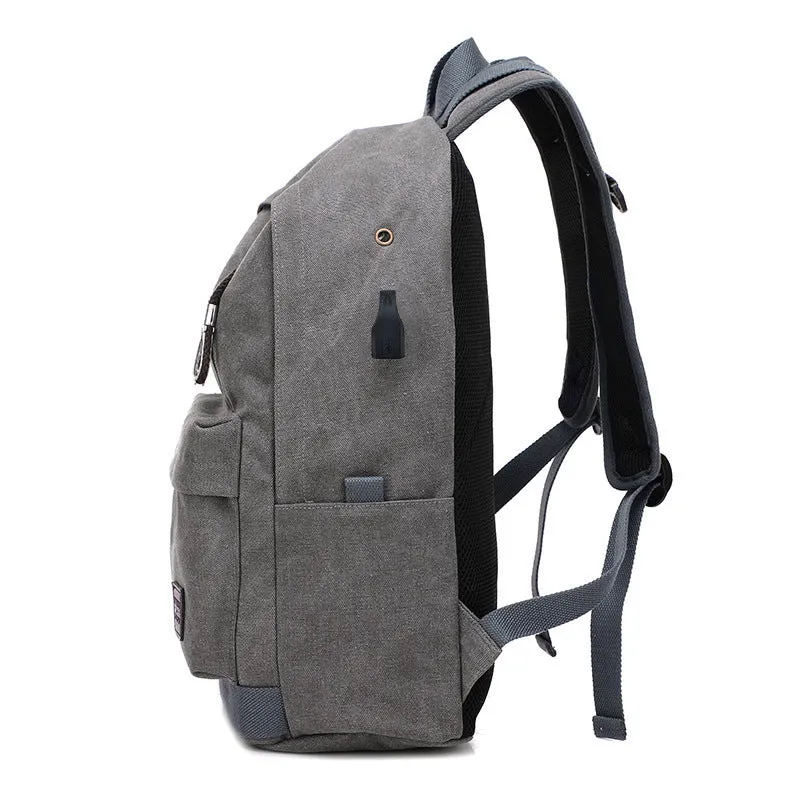 Canvas backpack with USB charging port and multiple compartments including separate laptop pocket