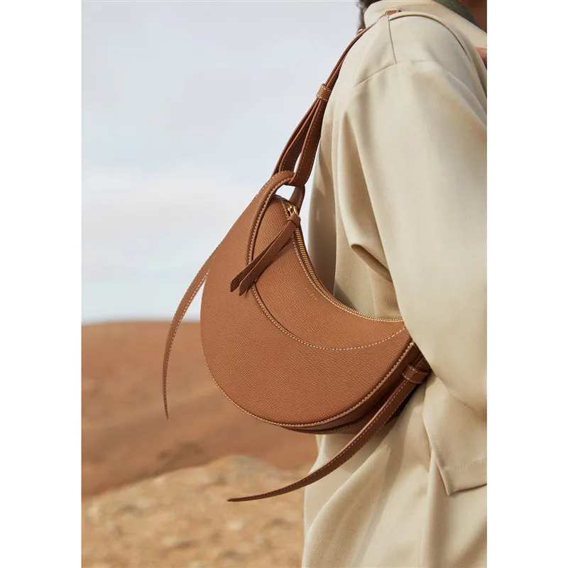 Women's crescent shoulder bag with litchi pattern texture, available in camel, black, chalk white, and elephant gray