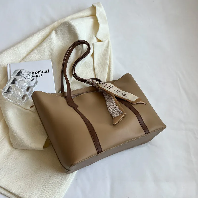Soft large tote shoulder bag with crossbody strap in multiple colour options including black, khaki, and white with coloured trim