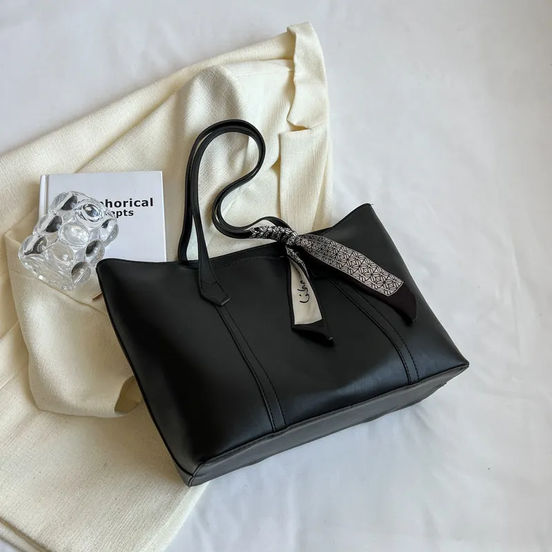 Soft large tote shoulder bag with crossbody strap in multiple colour options including black, khaki, and white with coloured trim