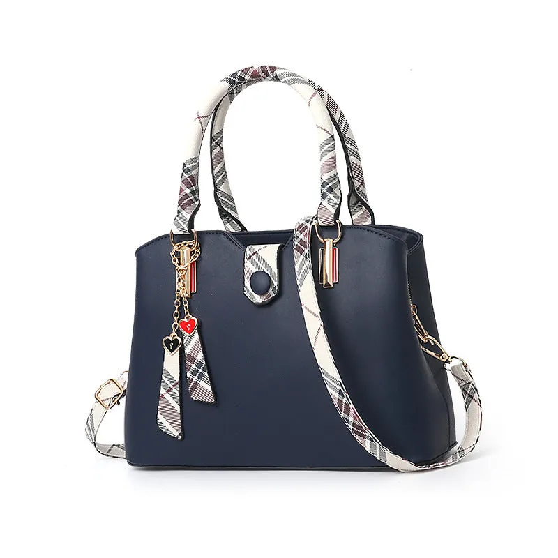 Ladies handbag in PU leather, medium Boston bag shape, square vertical section, with zipper closure and metal accents