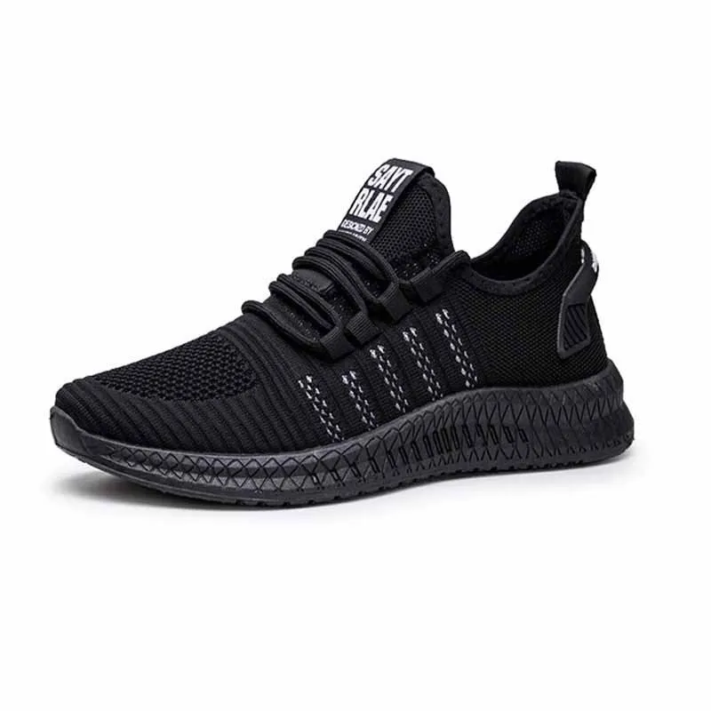 Men's low-top black casual trainers with cross-strap detail and flying weave upper, shown on a white background.