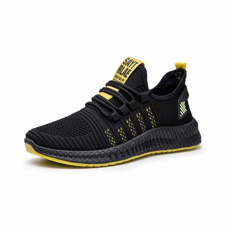Men's low-top black casual trainers with cross-strap detail and flying weave upper, shown on a white background.