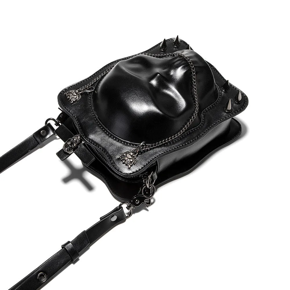 Black mini square crossbody bag with embossed skull design, metal chain strap, and zip opening.