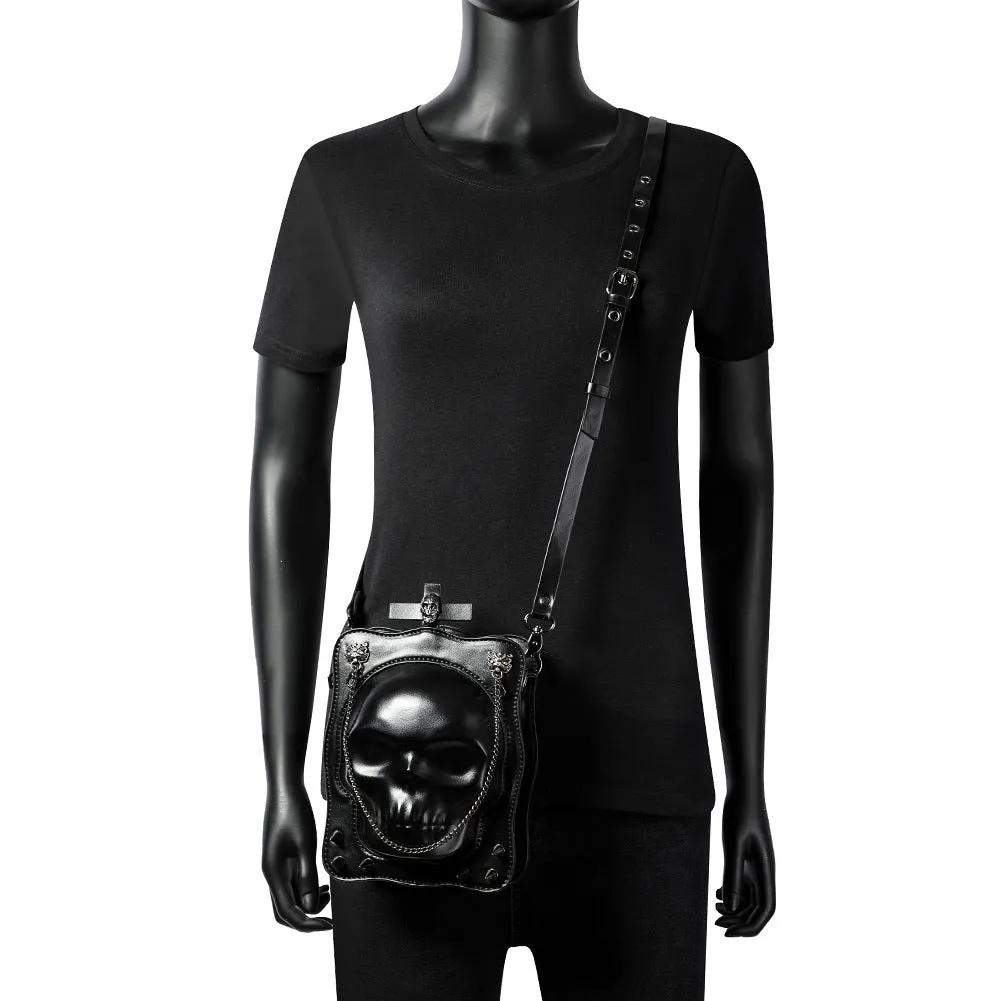 Black mini square crossbody bag with embossed skull design, metal chain strap, and zip opening.