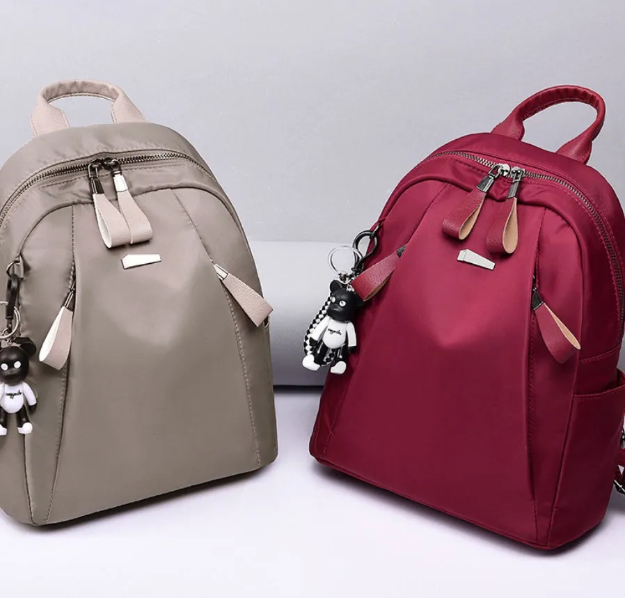 Medium square Oxford cloth rucksack in wine red with double straps and a front patch pocket.