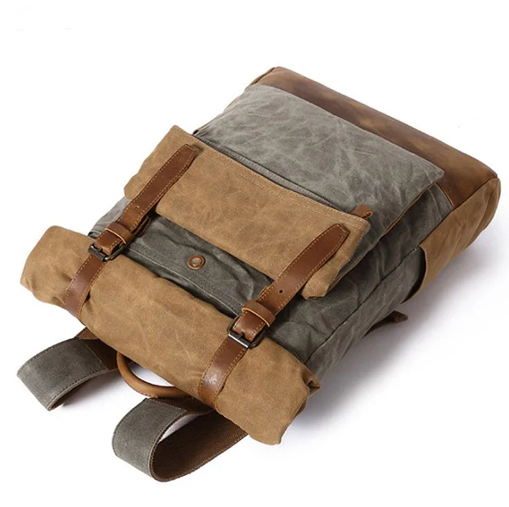Canvas vintage backpack in khaki showing front zipper pocket and curved shoulder straps with retro square shape