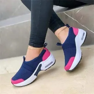 Women's flat sneakers in light grey with mesh upper, round toe, and rubber sole on a white background