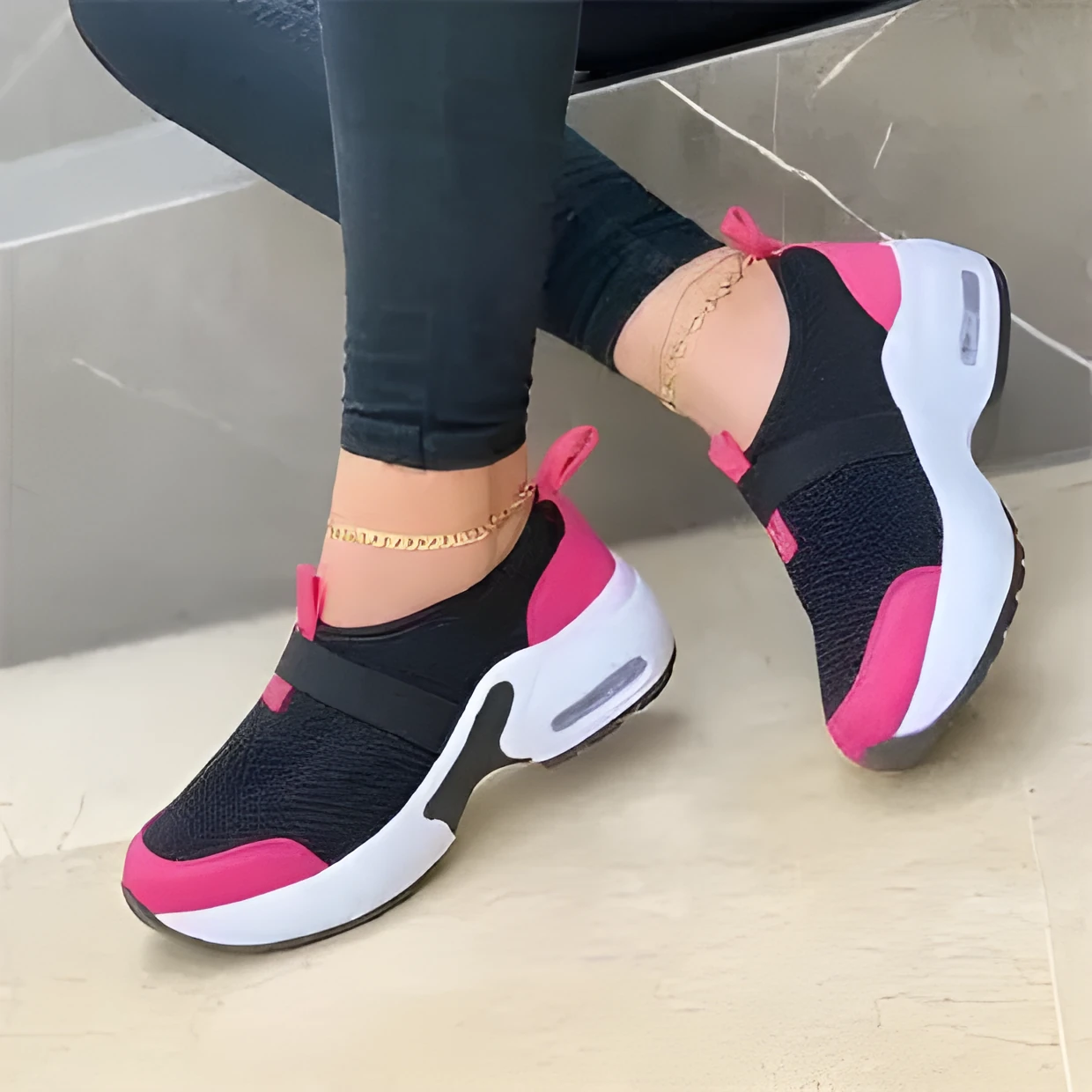 Women's flat sneakers in light grey with mesh upper, round toe, and rubber sole on a white background