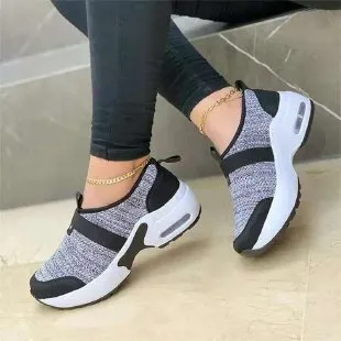 Women's flat sneakers in light grey with mesh upper, round toe, and rubber sole on a white background