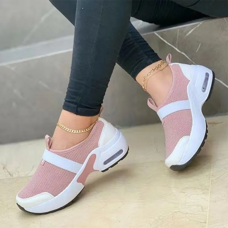 Women's flat sneakers in light grey with mesh upper, round toe, and rubber sole on a white background