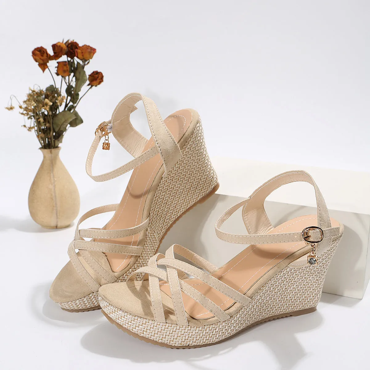 Women's black wedge sandals with cloth upper and fish-mouth toe design on a simple background.