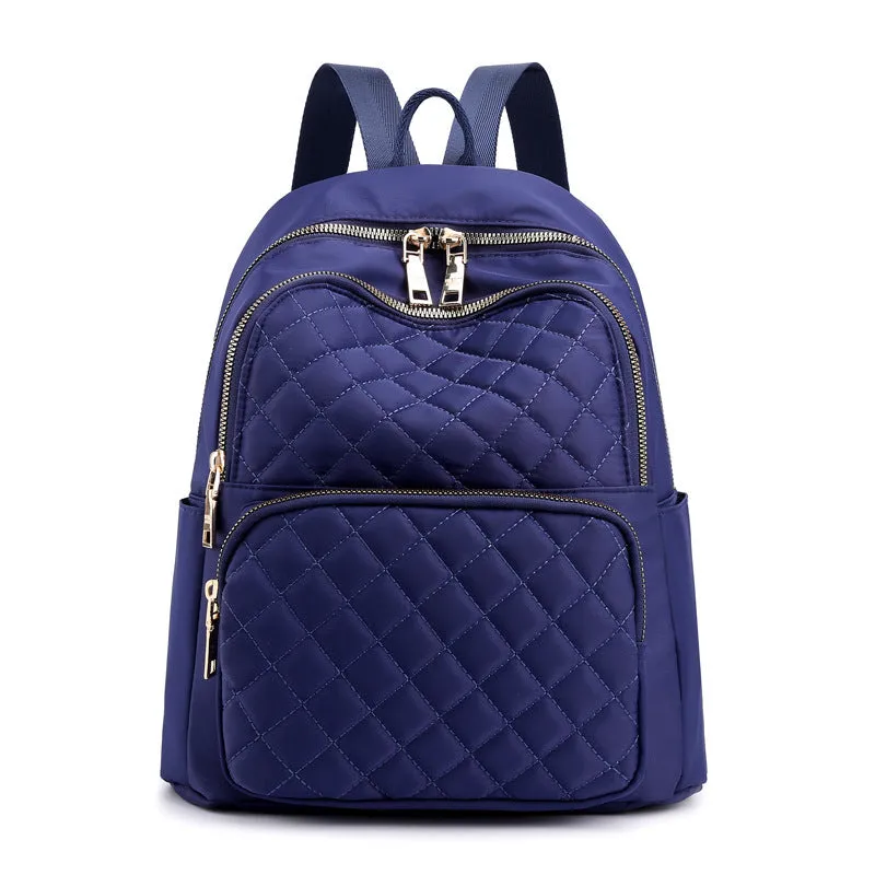 Women nylon embossed casual backpack in blue with zippered closure and soft handle