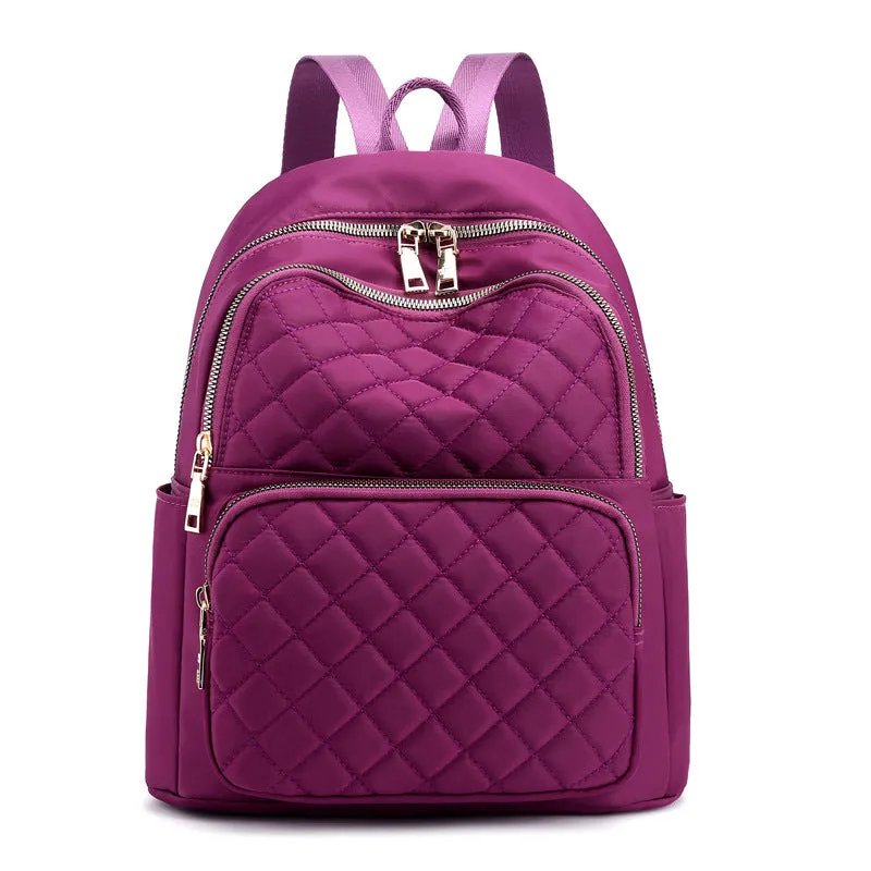 Women nylon embossed casual backpack in blue with zippered closure and soft handle