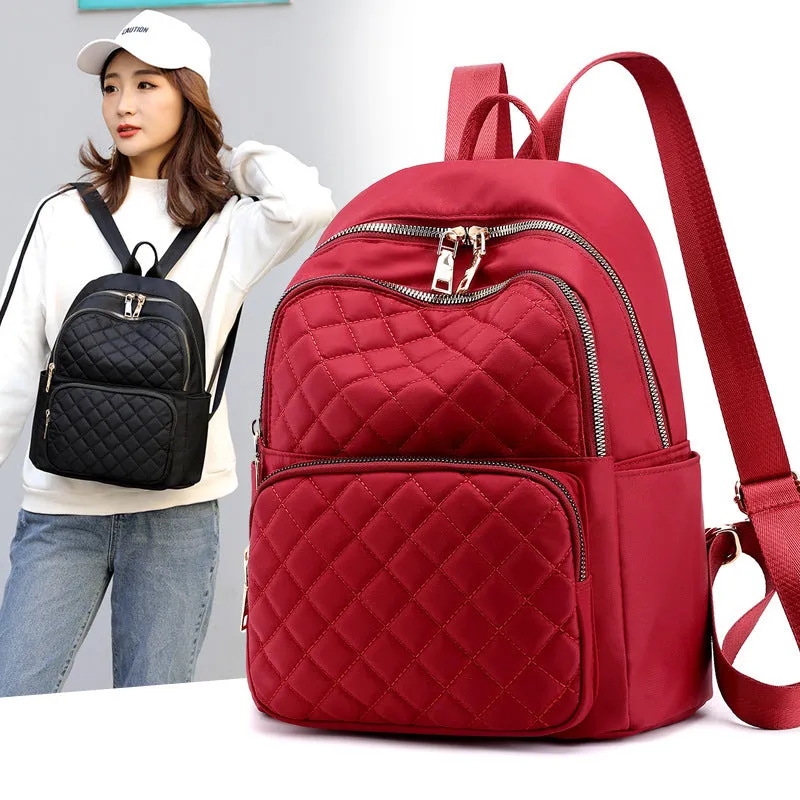 Women nylon embossed casual backpack in blue with zippered closure and soft handle