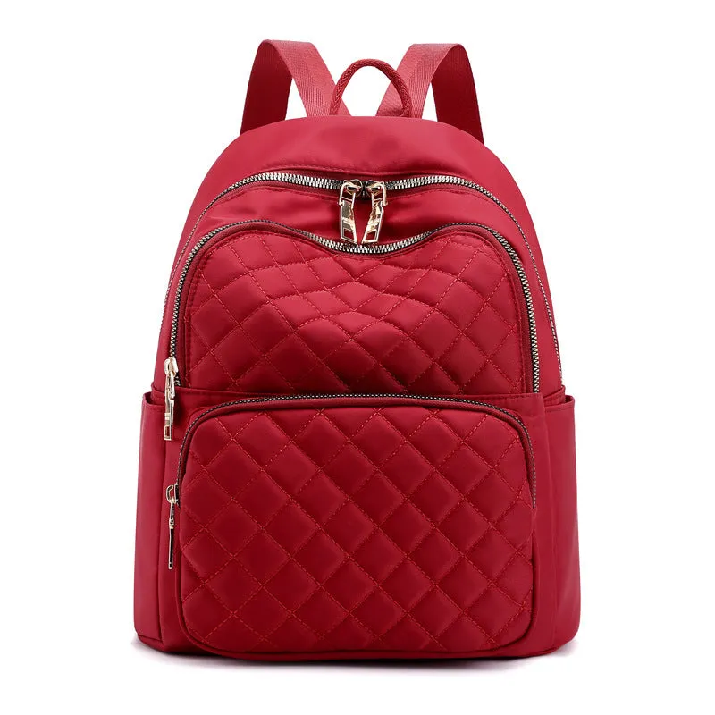 Women nylon embossed casual backpack in blue with zippered closure and soft handle