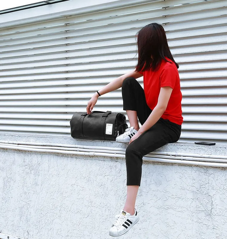 Black waterproof sports bag with separate side shoe compartments and diagonal shoulder straps