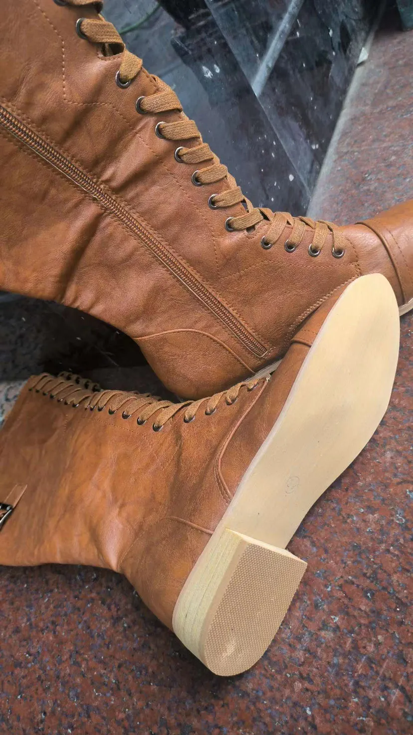 Women's black cross strap knight boots made from artificial PU, showing the strap detail and ankle height