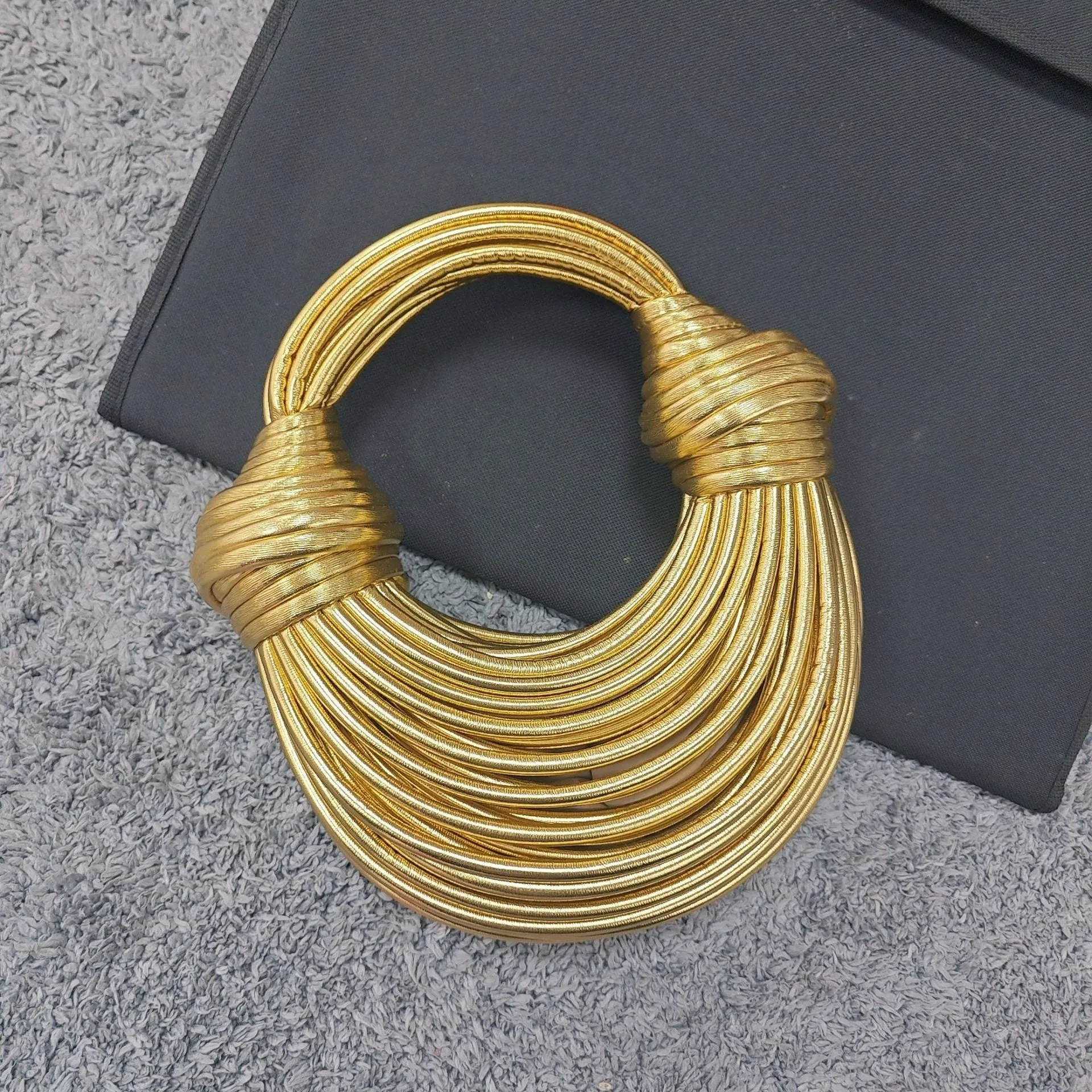 Instafamous Metal Noodles Underarm Bag with shiny metallic surface, chain detail, in gold colour
