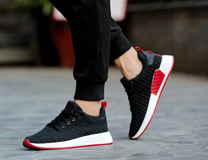 Men Malcolm Sneaker in black from side view showing mesh fabric upper and low-top design