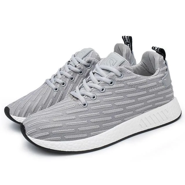 Men Malcolm Sneaker in black from side view showing mesh fabric upper and low-top design
