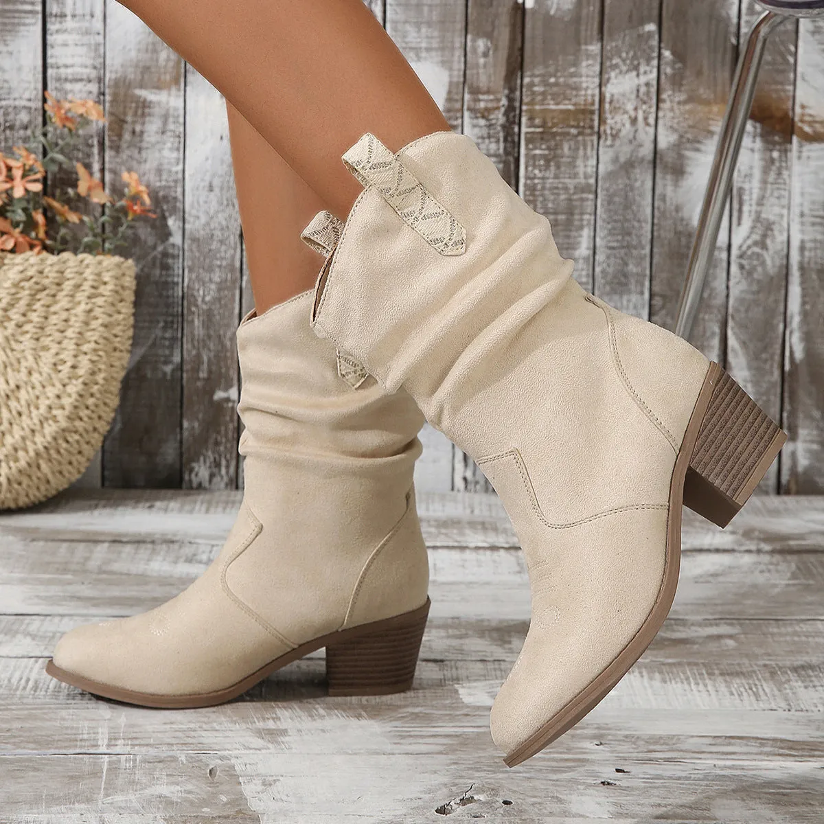 Women's suede mid-calf boots with a round toe and short stout heel on a rubber sole.