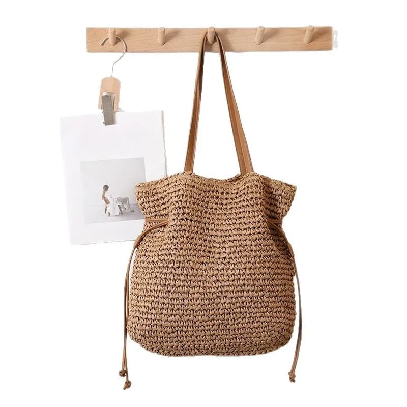 Large capacity paper straw drawstring shoulder bag in beige with double straps and inner pocket
