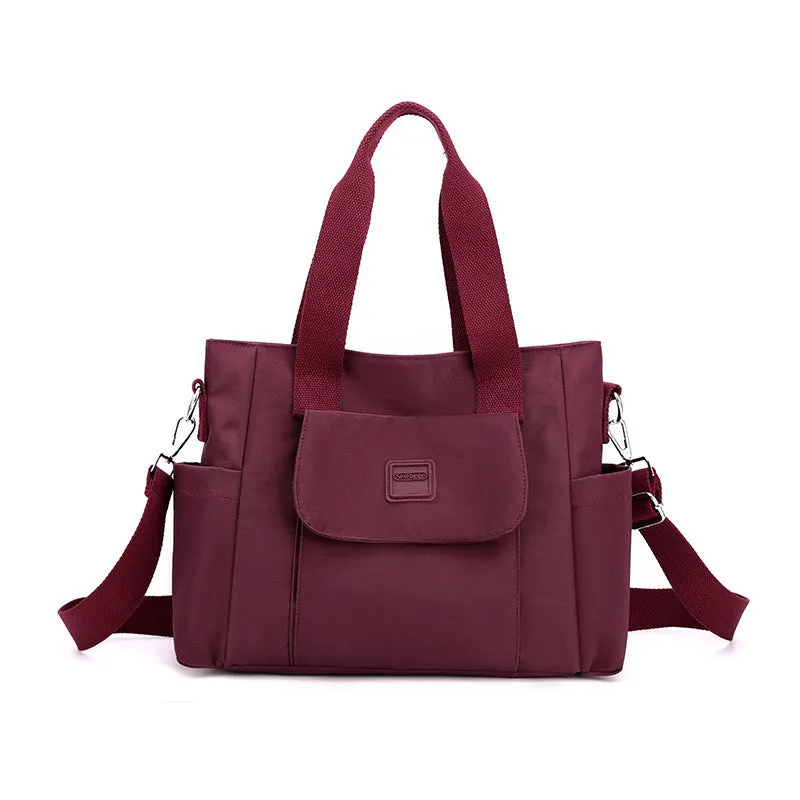 Women's large capacity multi-interlayer shoulder bag in nylon, soft horizontal square shape with sewing line detail, multiple internal compartments, urban simplicity style